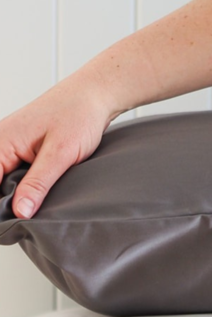 Close up of Coal mine pillowcase with hand touching the fabric