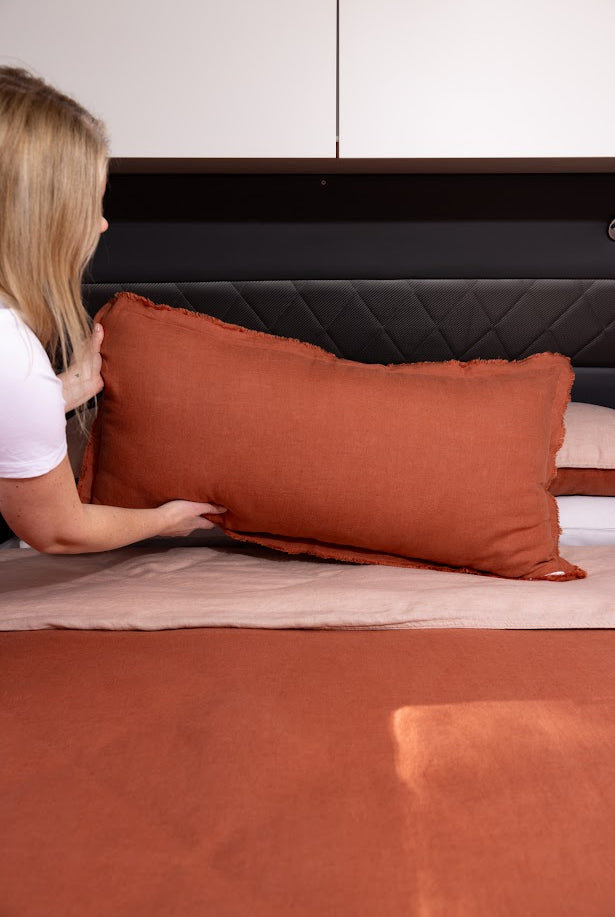 Desert Rose Lifestyle Lumbar Cushion styled on caravan bed