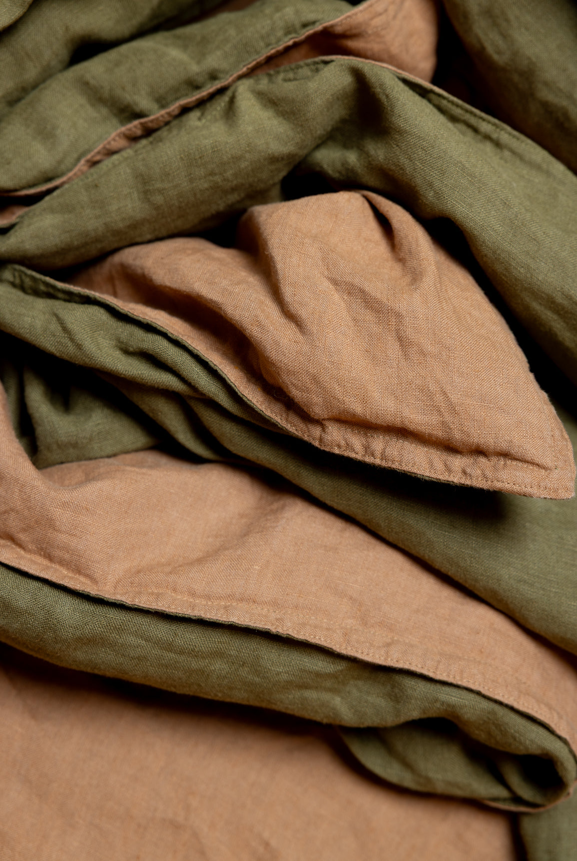 Stack of folded fabric in brown and green shades