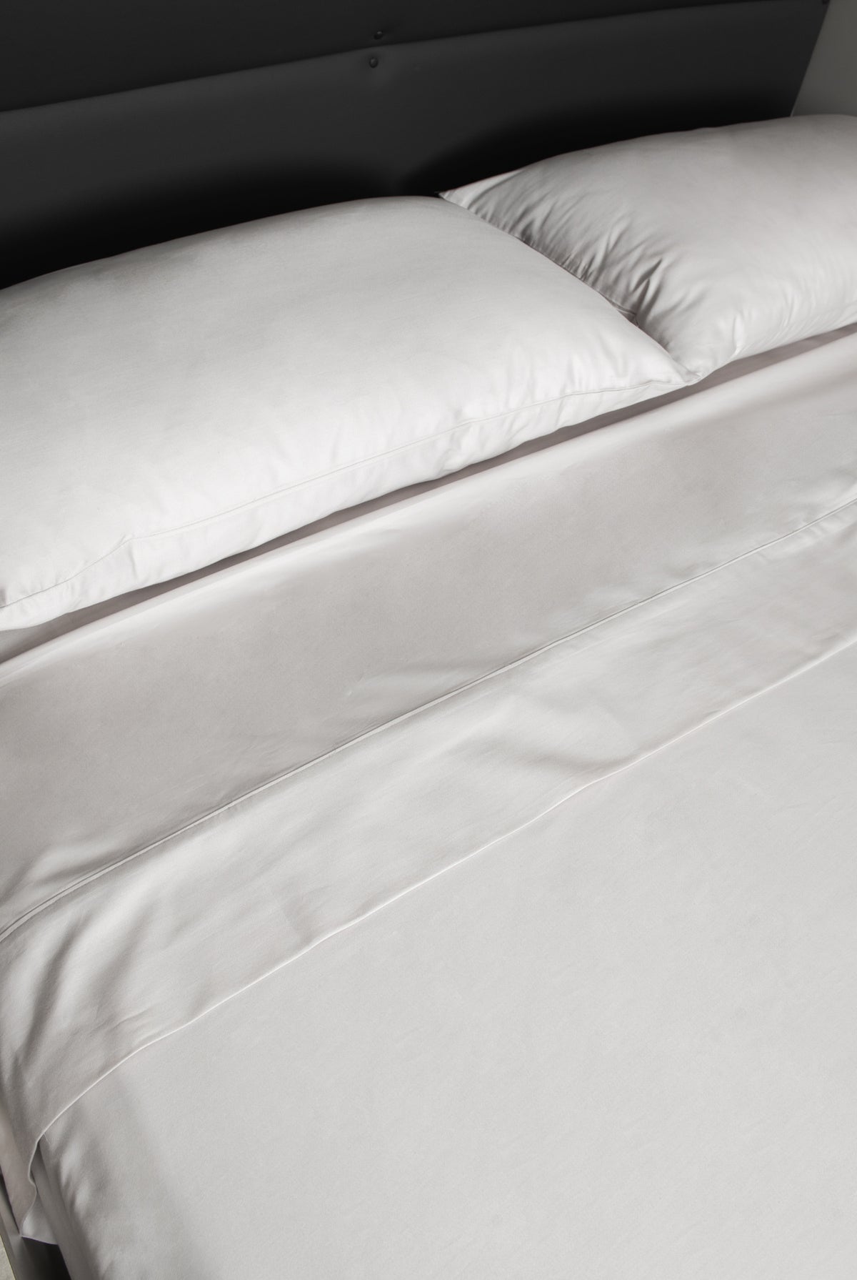 Zoom in detail of Driftwood Pillowcases and top of bed sheet folded back