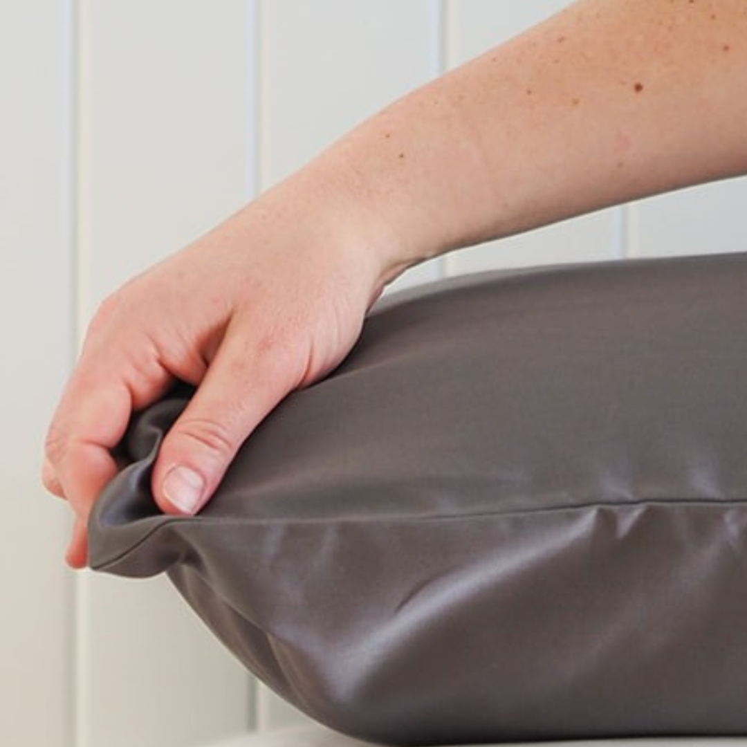 Close up of Coal mine pillowcase with hand touching the fabric