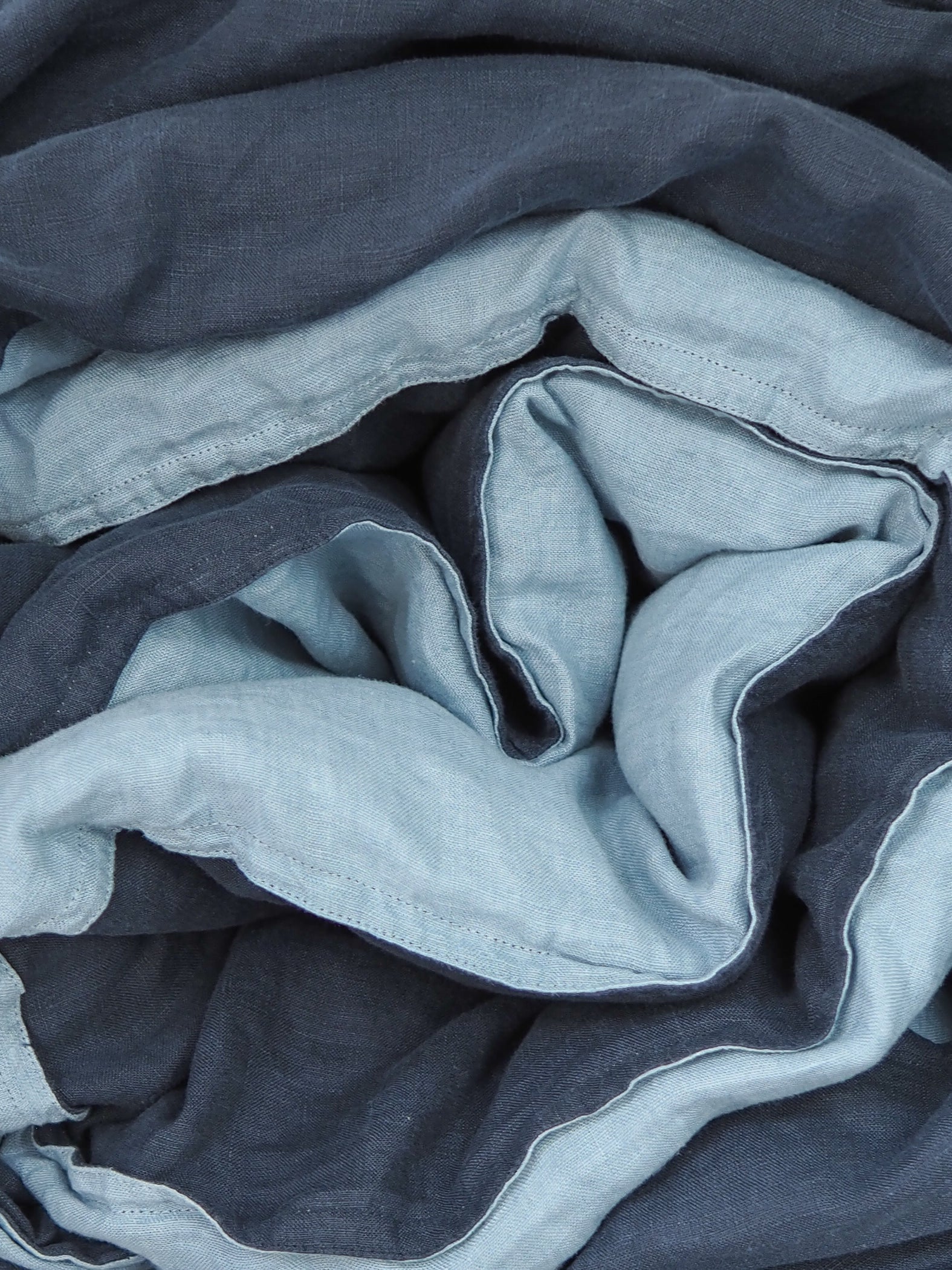 A quilt cover and pillowcase set in navy blue colour with taupe backing