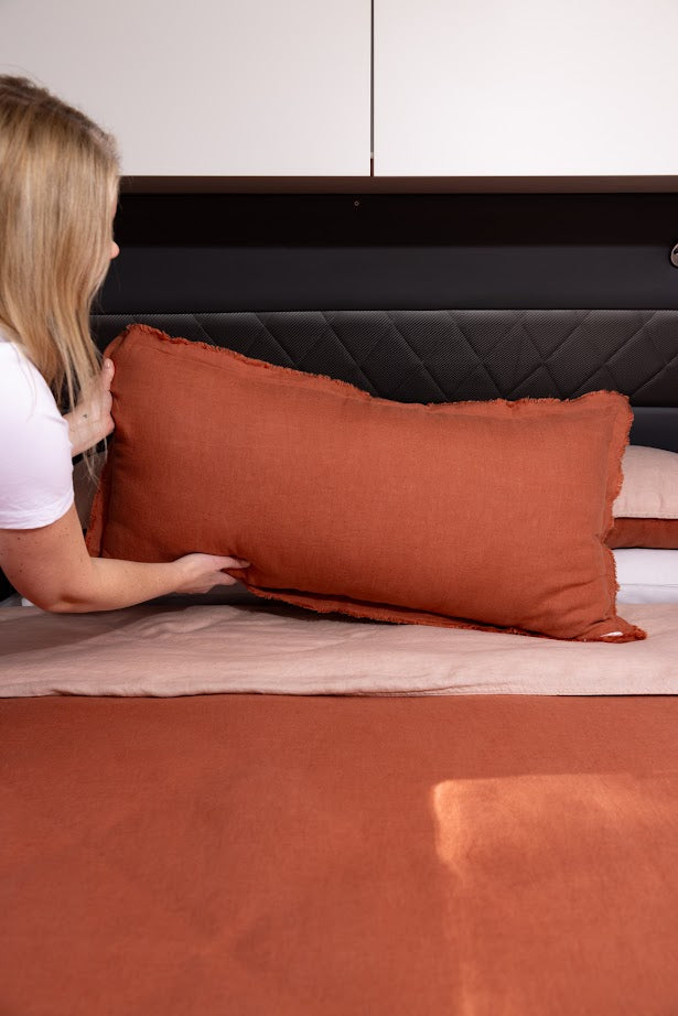 Desert Rose Lifestyle Lumbar Cushion styled on caravan bed