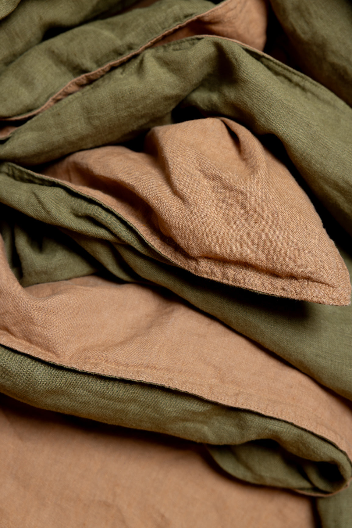 Stack of folded fabric in brown and green shades