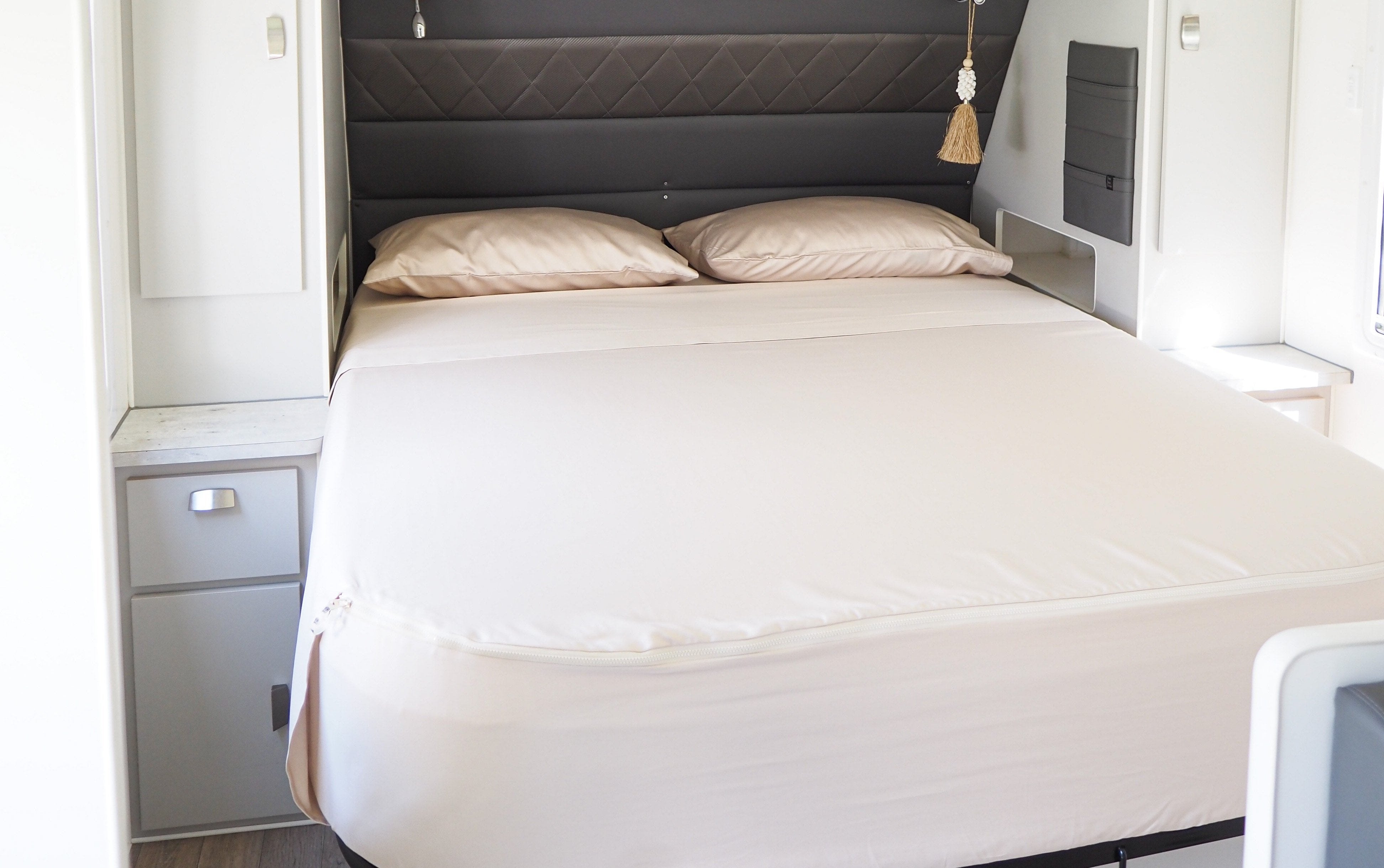 Caravan bed featuring MeanderWild Sheet set in Dune