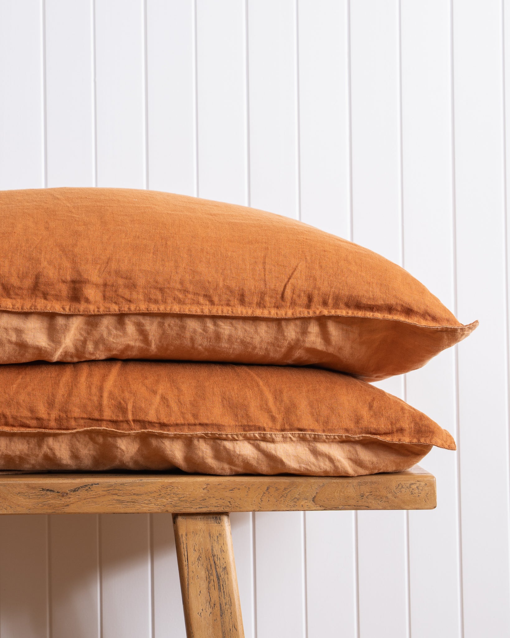 Ochre Pillow stack on white wall 