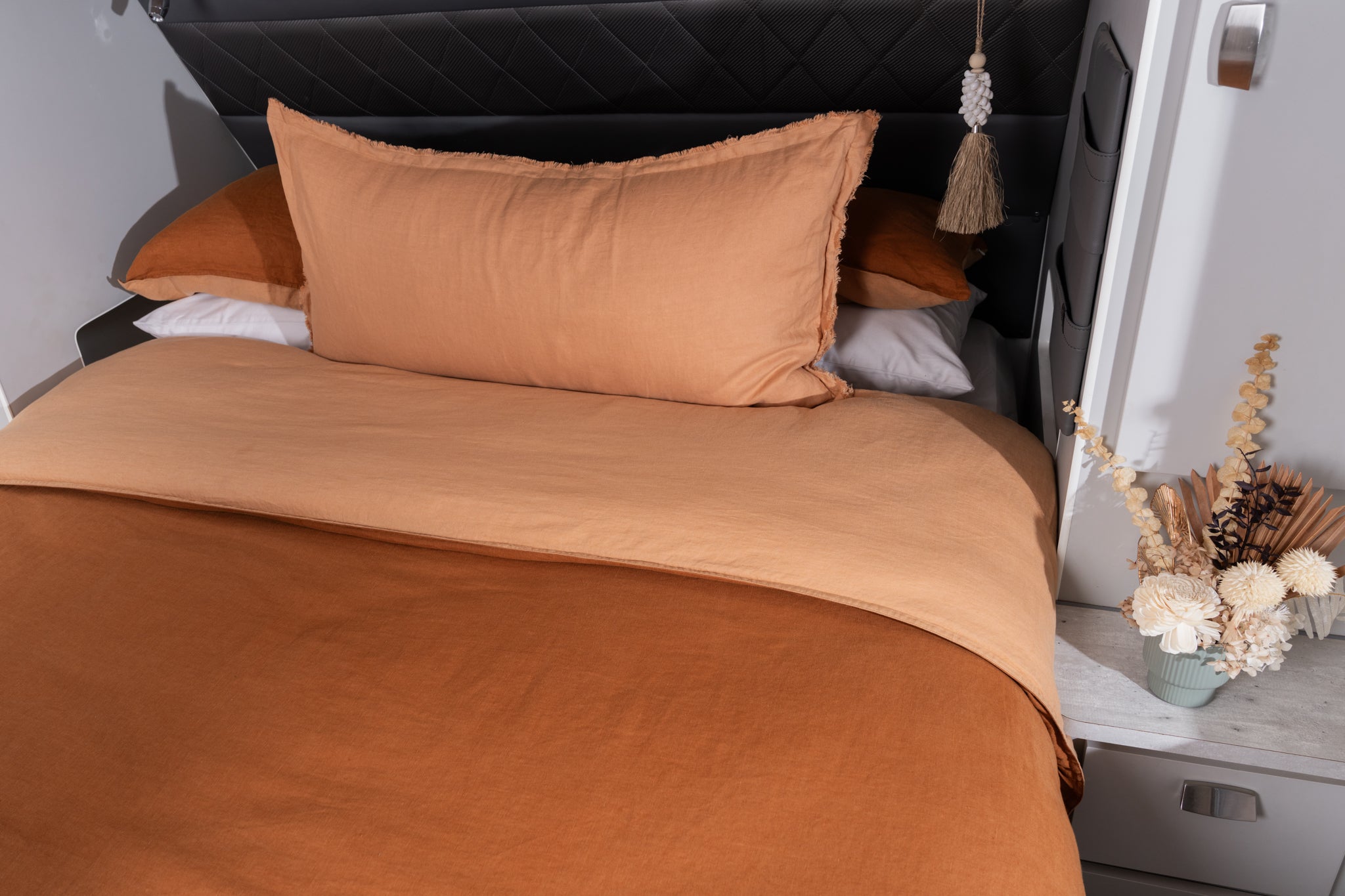 A burnt orange and peach quilt cover featured in a caravan