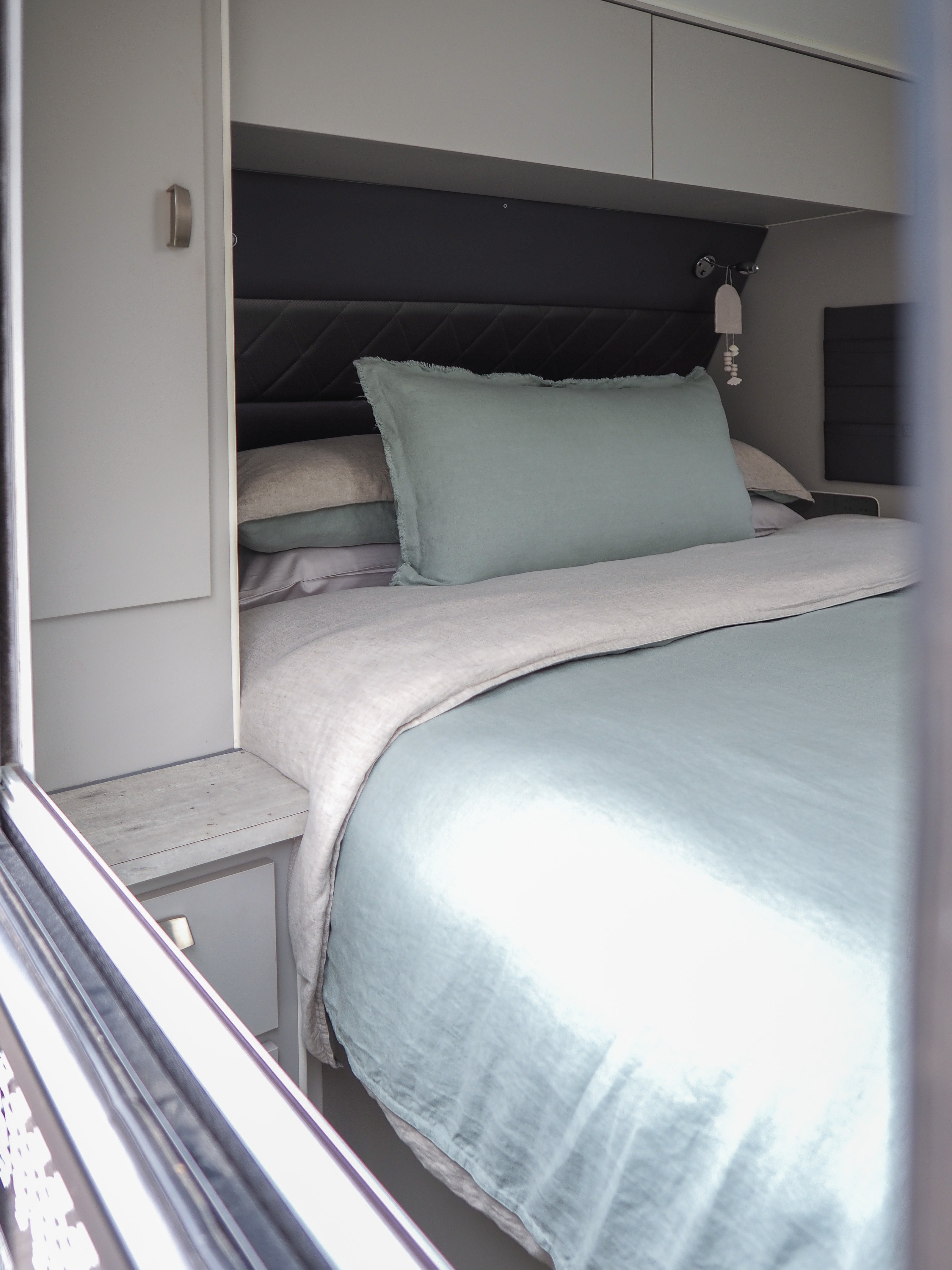 looking in the window of a caravan at the seaglass quilt cover