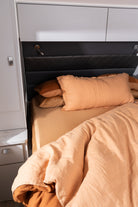 Close up of Wildfire sheet set and Ochre Doona Cover